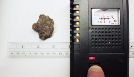 Thorite - Kemp Uranium Mine, Cardiff Township, Ontario, Canada, about 1 inch from Geiger counter beta slots